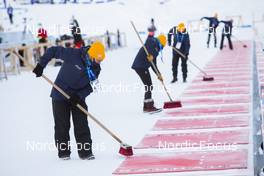 14.12.2021, Annecy-Le Grand Bornand, France (FRA): Event Feature: Volunteers clean the shooting mats -  IBU World Cup Biathlon, training, Annecy-Le Grand Bornand (FRA). www.nordicfocus.com. © Manzoni/NordicFocus. Every downloaded picture is fee-liable.