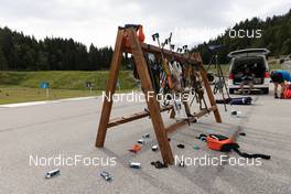 28.06.2022, Premanon, France (FRA): Event Feature: Riffle rack with riffles and packages of bullets on the ground - Biathlon summer training, Premanon (FRA). www.nordicfocus.com. © Manzoni/NordicFocus. Every downloaded picture is fee-liable.