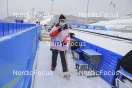 12.02.2022, Beijing, China (CHN): Event Feature: Volunteers prepare the stadium for the competition and remove the snow - XXIV. Olympic Winter Games Beijing 2022, Biathlon, training, Beijing (CHN). www.nordicfocus.com. © Manzoni/NordicFocus. Every downloaded picture is fee-liable.
