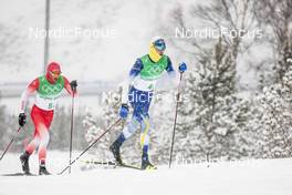 13.02.2022, Beijing, China (CHN): William Poromaa (SWE), Jonas Baumann (SUI), (l-r)  - XXIV. Olympic Winter Games Beijing 2022, cross-country, 4x10km men, Beijing (CHN). www.nordicfocus.com. © Modica/NordicFocus. Every downloaded picture is fee-liable.