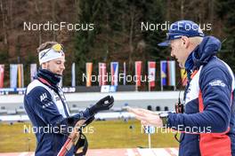 15.01.2023, Ruhpolding, Germany (GER): Sturla Holm Laegreid (NOR), Siegfried Mazet (FRA) coach team Norway, (l-r) - IBU World Cup Biathlon, mass men, Ruhpolding (GER). www.nordicfocus.com. © Manzoni/NordicFocus. Every downloaded picture is fee-liable.