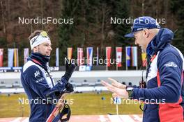 15.01.2023, Ruhpolding, Germany (GER): Sturla Holm Laegreid (NOR), Siegfried Mazet (FRA) coach team Norway, (l-r) - IBU World Cup Biathlon, mass men, Ruhpolding (GER). www.nordicfocus.com. © Manzoni/NordicFocus. Every downloaded picture is fee-liable.