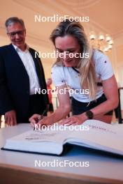 12.08.2023, Wiesbaden, Germany (GER): Denise Herrmann-Wick (GER) signs the golden book of Wiesbaden- City Biathlon - Wiesbaden (GER). www.nordicfocus.com. © Manzoni/NordicFocus. Every downloaded picture is fee-liable.