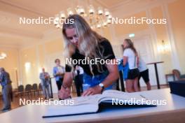 12.08.2023, Wiesbaden, Germany (GER): Anna Gandler (AUT) signs the golden book of Wiesbaden - City Biathlon - Wiesbaden (GER). www.nordicfocus.com. © Manzoni/NordicFocus. Every downloaded picture is fee-liable.